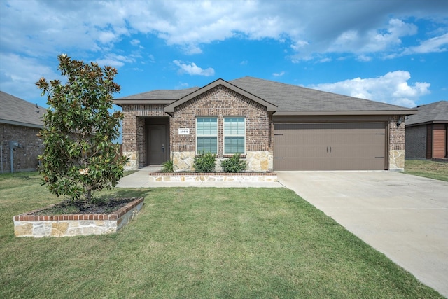 view of front of house featuring a garage and a front lawn