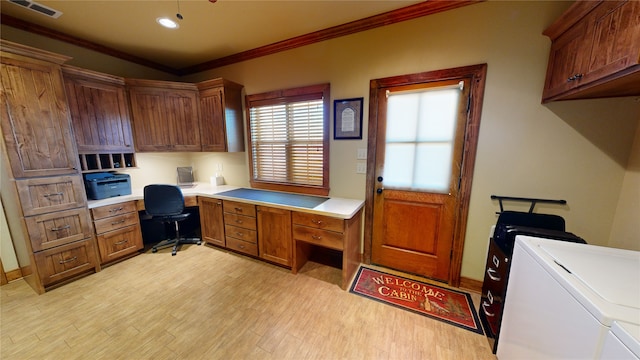 office featuring crown molding, built in desk, washer and dryer, and light wood-type flooring