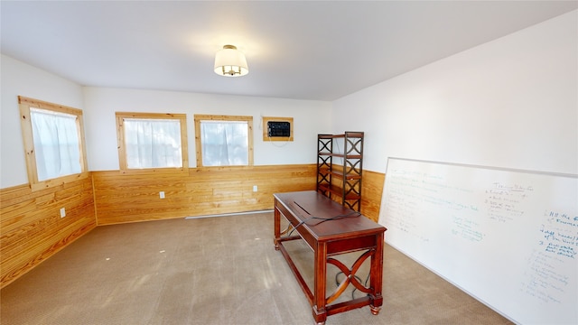 office area with carpet floors and wooden walls