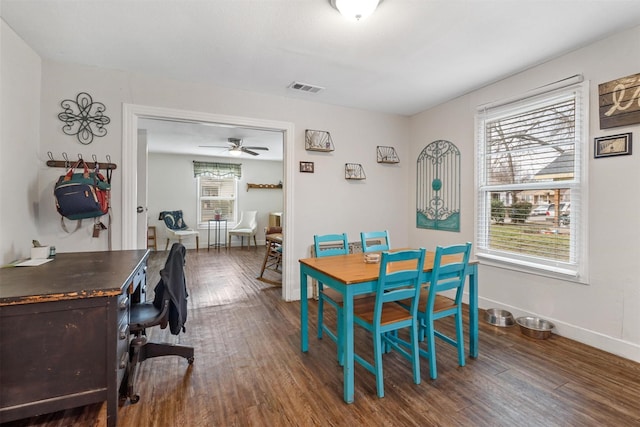 dining space with ceiling fan and dark hardwood / wood-style flooring