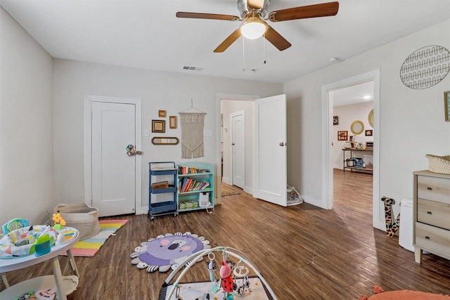 playroom featuring ceiling fan and dark hardwood / wood-style flooring