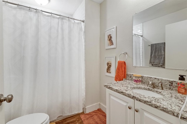 bathroom with vanity, hardwood / wood-style floors, and toilet