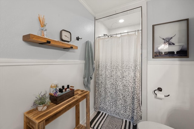 bathroom featuring crown molding, toilet, and walk in shower