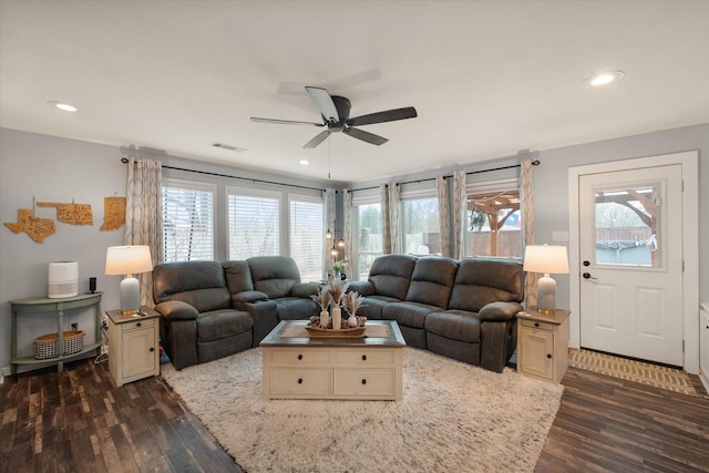 living room with ceiling fan, dark wood-type flooring, and a healthy amount of sunlight