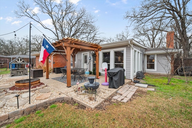 back of property with an outdoor fire pit, a pergola, a patio, and a lawn