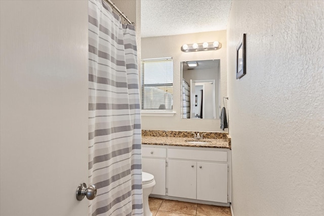 bathroom featuring tile patterned floors, toilet, a textured ceiling, vanity, and a shower with shower curtain