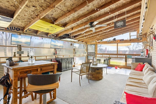 sunroom / solarium featuring ceiling fan