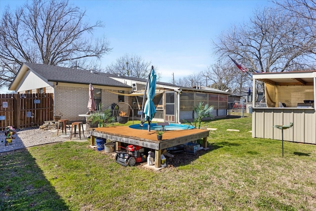 rear view of property with a yard and a sunroom