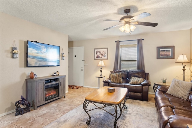 living room with ceiling fan and a textured ceiling