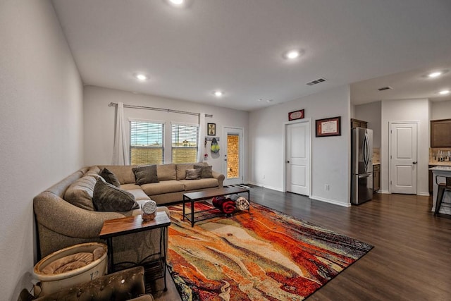 living room with dark hardwood / wood-style flooring