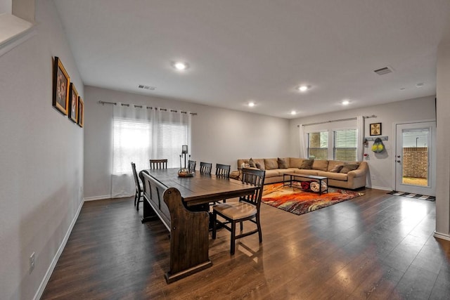 dining space with dark hardwood / wood-style flooring