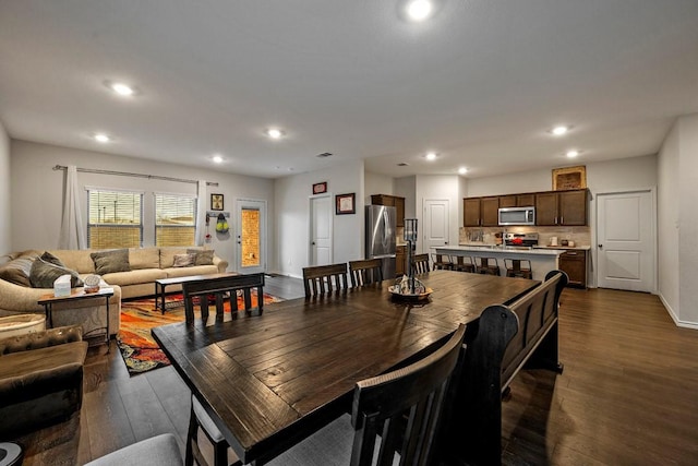 dining area featuring dark wood-type flooring