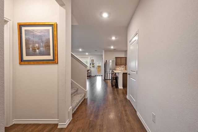 hall featuring dark hardwood / wood-style floors and sink