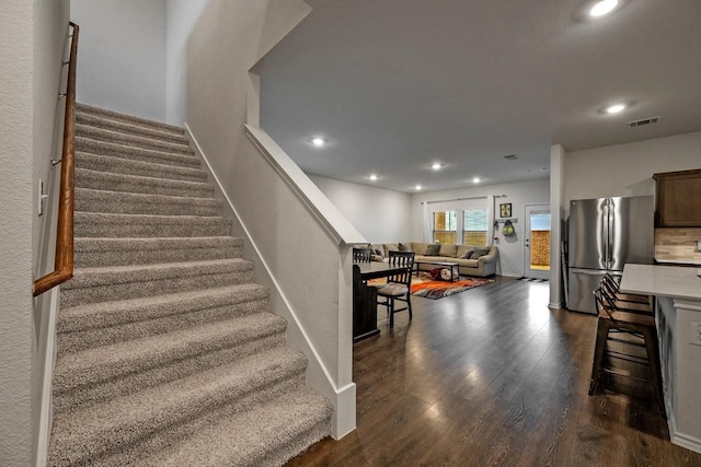 stairway featuring wood-type flooring