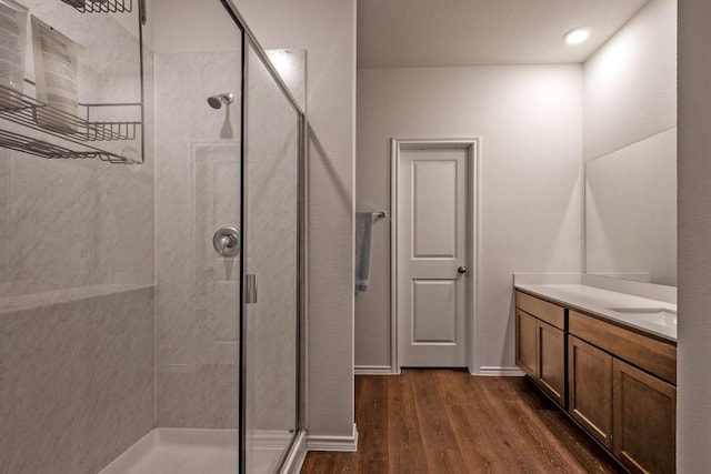 bathroom featuring vanity, an enclosed shower, and hardwood / wood-style floors