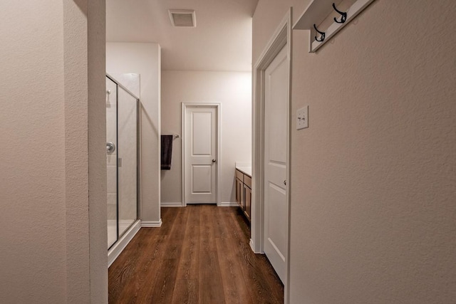 hallway with dark wood-type flooring