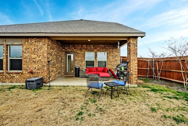 rear view of house featuring a patio area, outdoor lounge area, and a lawn