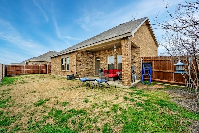 back of house with a lawn and a patio area