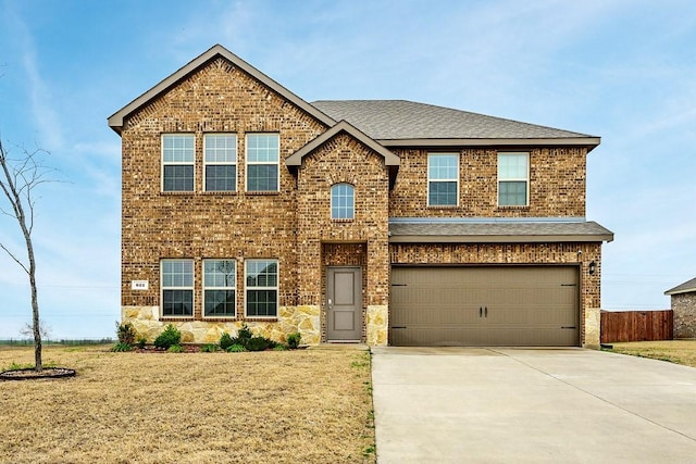 view of front of home featuring a garage and a front lawn