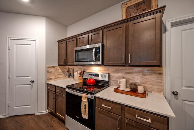 kitchen with decorative backsplash, dark brown cabinets, dark hardwood / wood-style floors, and appliances with stainless steel finishes