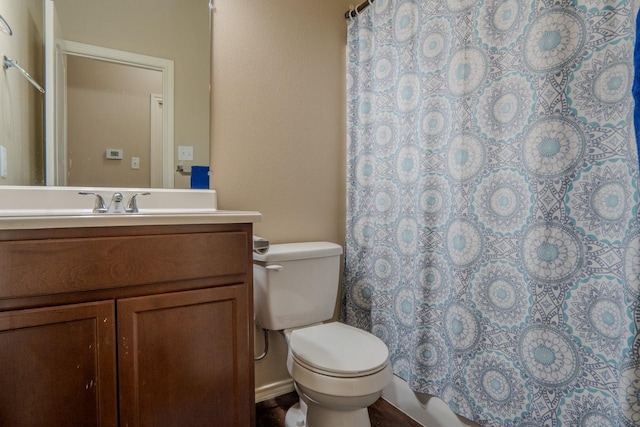 bathroom with vanity, toilet, and walk in shower