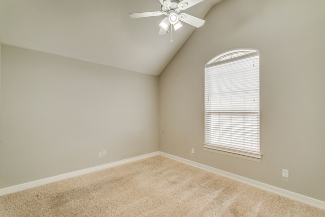 carpeted empty room with vaulted ceiling and ceiling fan