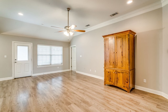 interior space featuring crown molding, ceiling fan, vaulted ceiling, and light hardwood / wood-style flooring