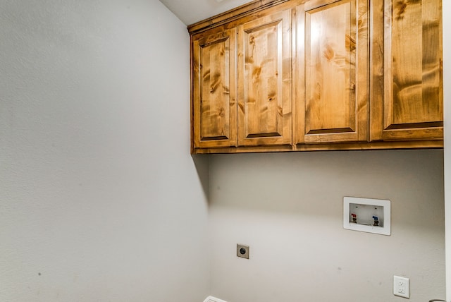 clothes washing area with cabinets, hookup for an electric dryer, and washer hookup