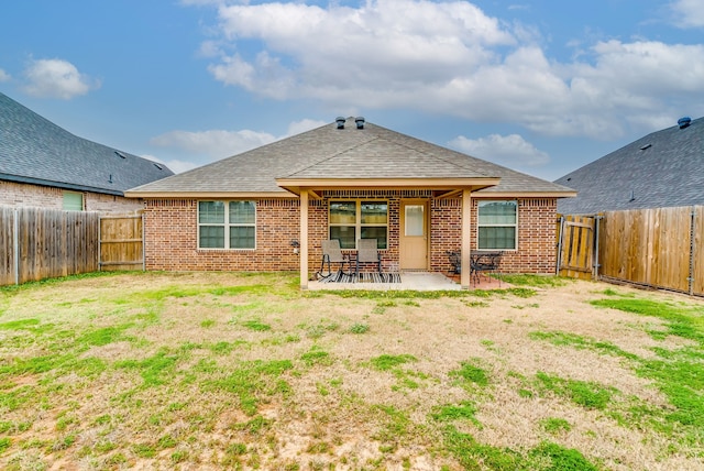 rear view of house with a yard and a patio area