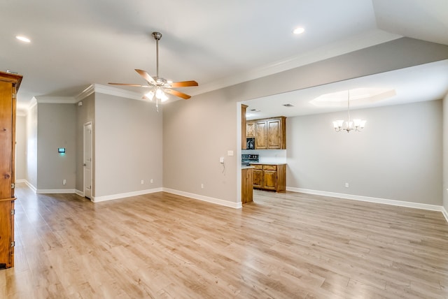 unfurnished living room with ceiling fan with notable chandelier, ornamental molding, and light hardwood / wood-style floors