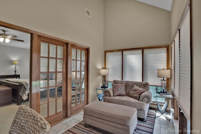 living room with french doors, ceiling fan, a high ceiling, and light tile patterned floors