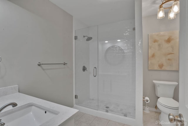 bathroom with tile patterned flooring, toilet, a shower stall, and vanity