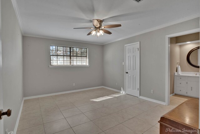 unfurnished bedroom with baseboards, connected bathroom, ceiling fan, crown molding, and light tile patterned flooring