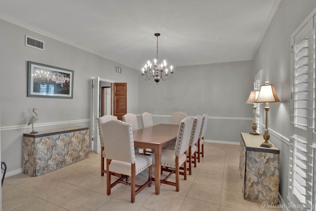 dining space with ornamental molding, visible vents, and an inviting chandelier