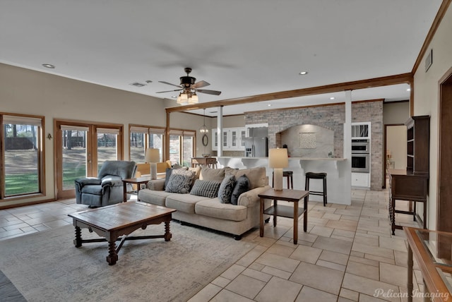 living area featuring a ceiling fan, recessed lighting, beam ceiling, and visible vents