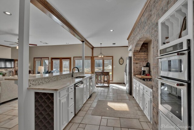 kitchen with white cabinetry, black electric stovetop, ornamental molding, light tile patterned flooring, and stainless steel double oven