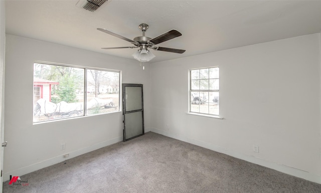 carpeted spare room featuring ceiling fan