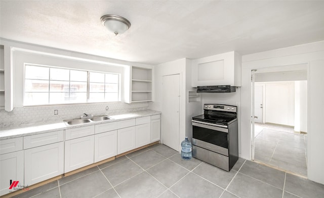 kitchen with extractor fan, sink, light tile patterned floors, electric range, and white cabinets