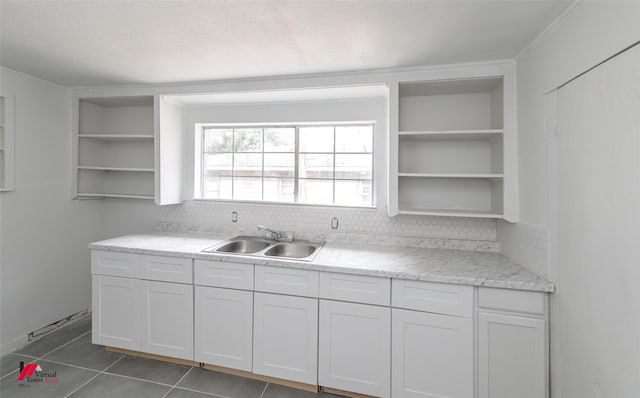 kitchen featuring sink, white cabinets, tile patterned floors, and decorative backsplash