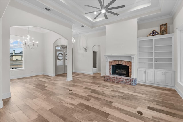 unfurnished living room with crown molding, light hardwood / wood-style floors, and a brick fireplace