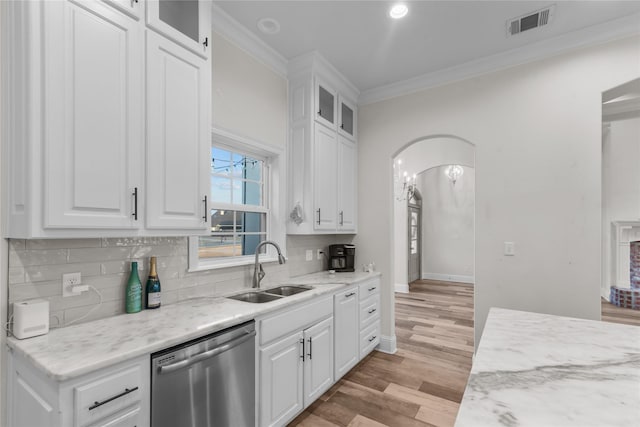 kitchen featuring sink, ornamental molding, light stone countertops, white cabinets, and stainless steel dishwasher