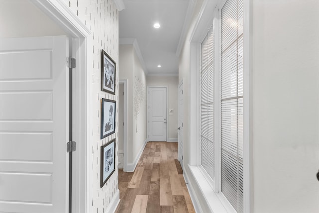 hall featuring ornamental molding and light hardwood / wood-style floors