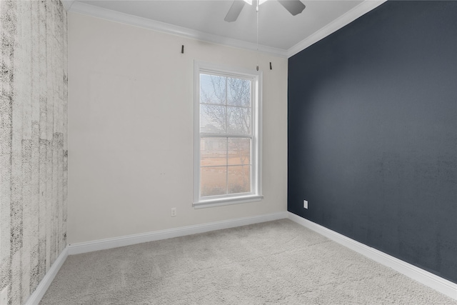 empty room with crown molding, ceiling fan, and carpet