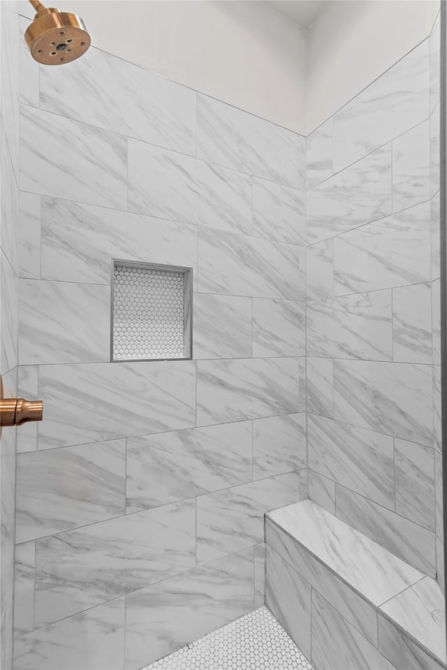 bathroom featuring a tile shower