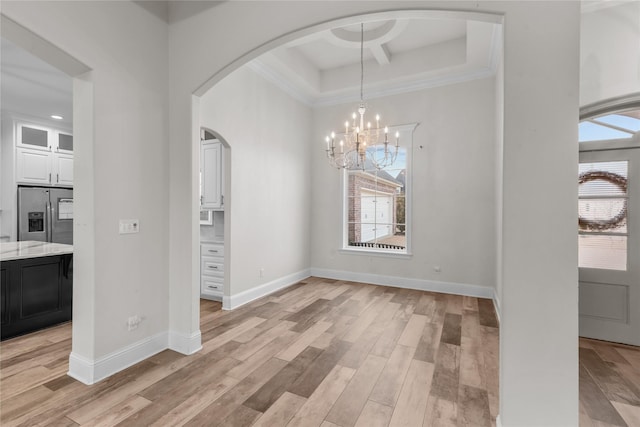 unfurnished dining area with a chandelier and light wood-type flooring