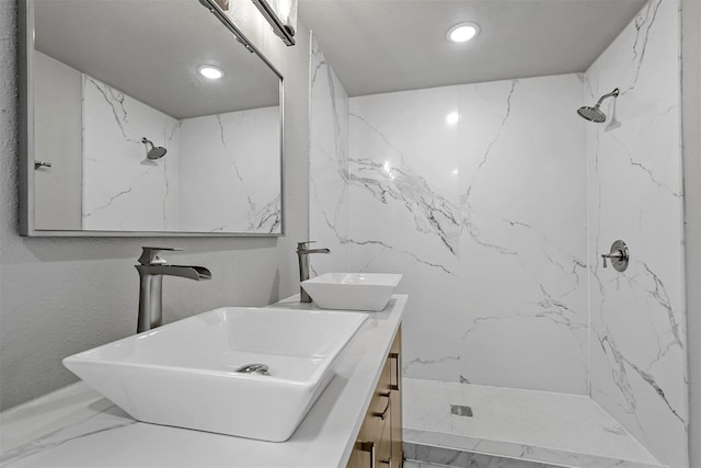 bathroom featuring vanity and a tile shower