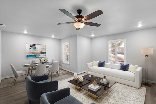 living room with hardwood / wood-style floors and ceiling fan