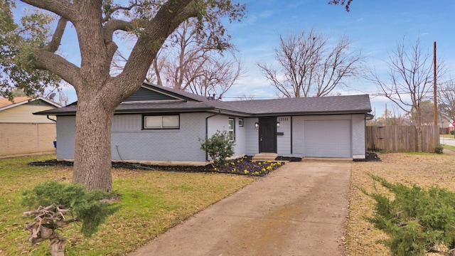 ranch-style house featuring a garage and a front lawn