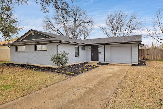 single story home featuring fence, a shingled roof, concrete driveway, a garage, and brick siding