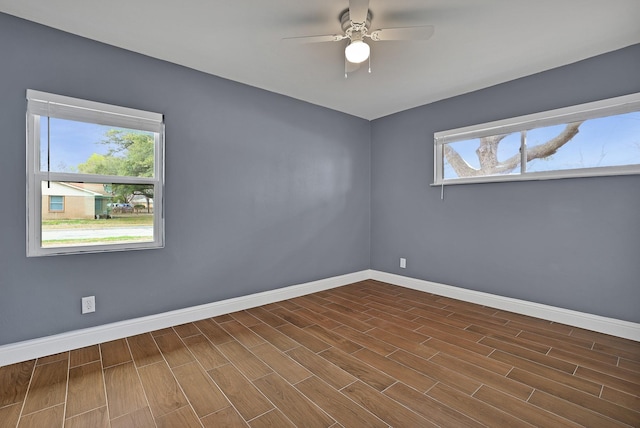 unfurnished room with ceiling fan, plenty of natural light, and dark hardwood / wood-style flooring